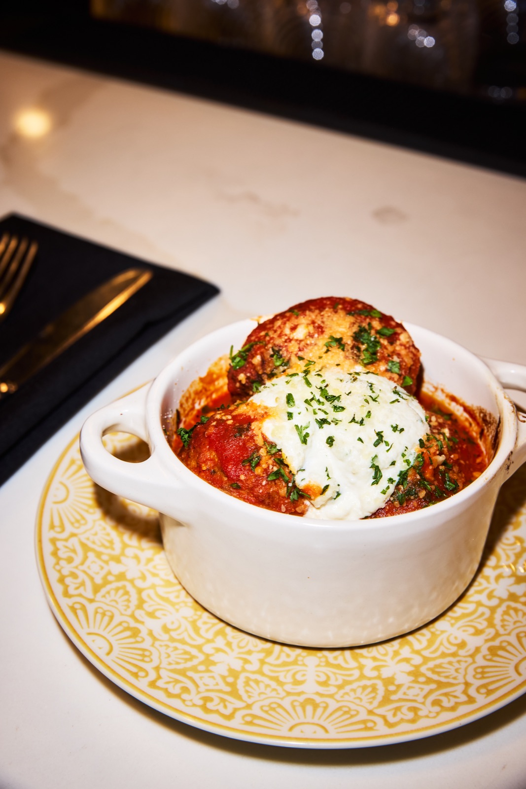 Meatballs with tomato sauce, ricotta and herbs