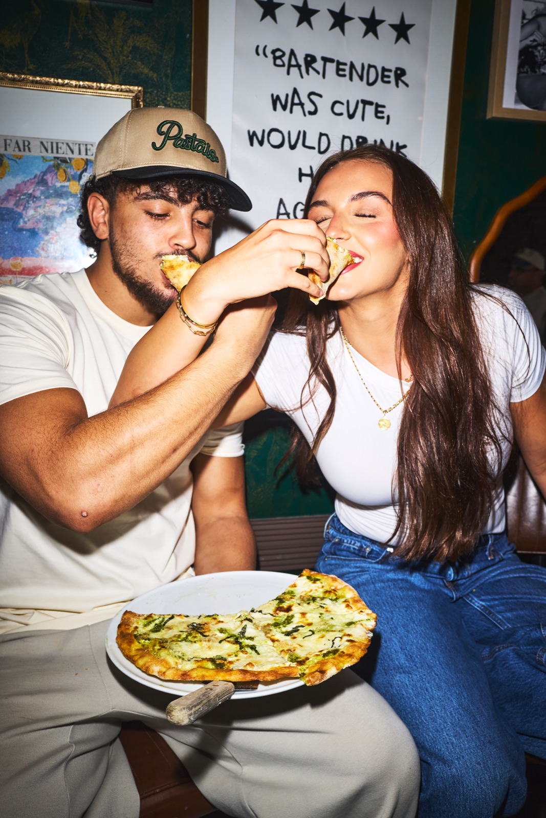 Two guests sharing pizza at Pastaio